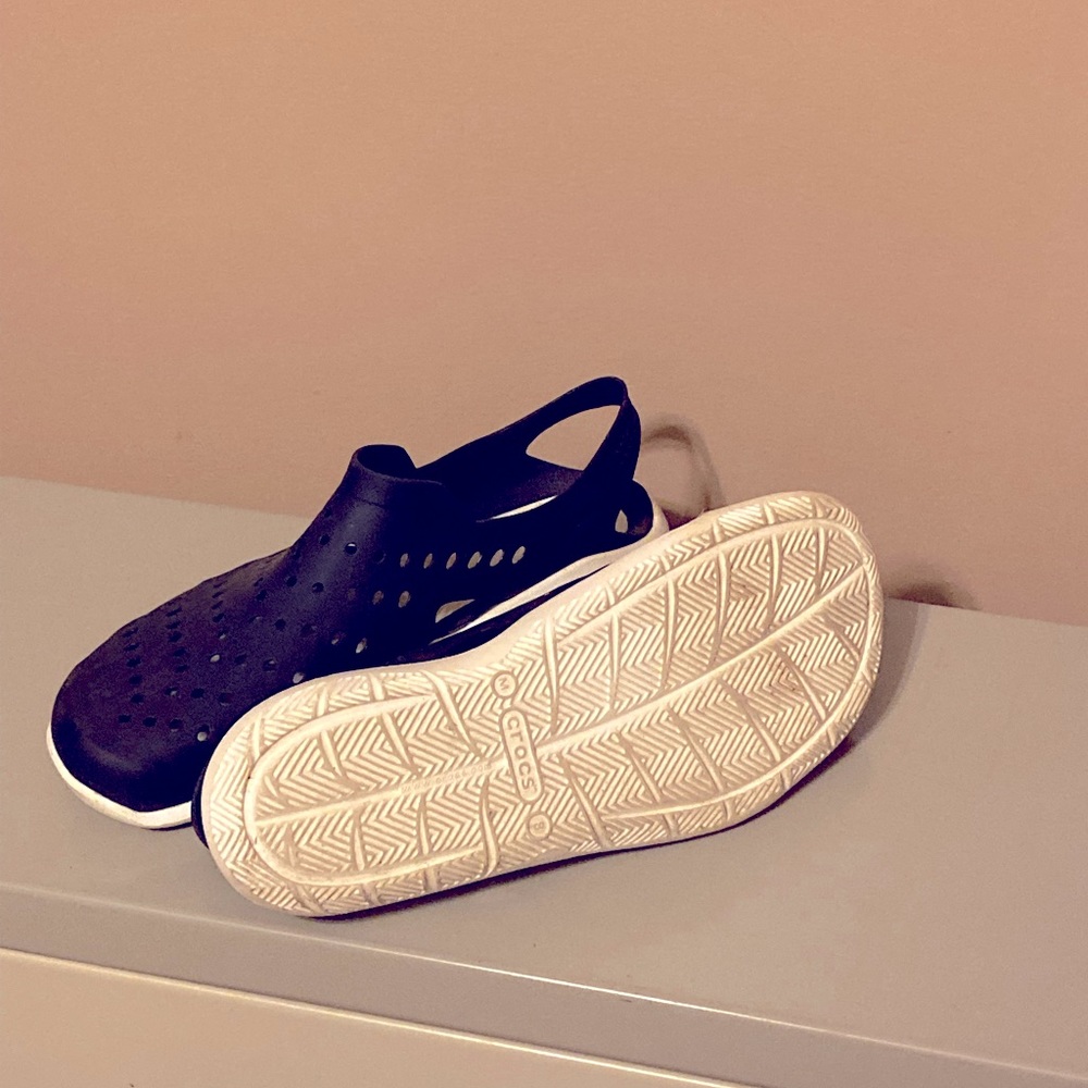 Croc shoes, slightly worn, seem to run a size larger. Color is Navy.